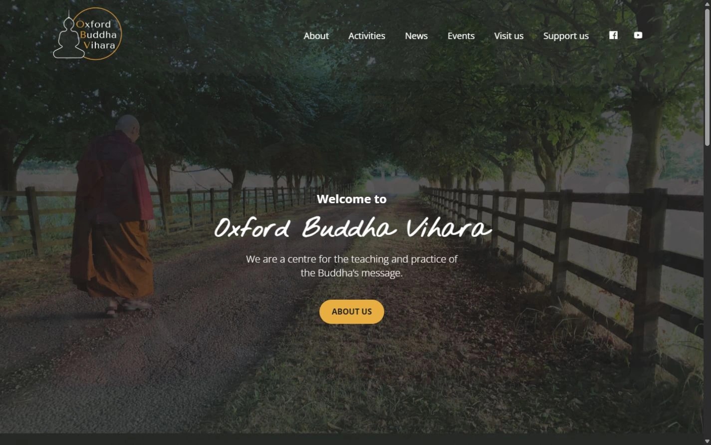 Oxford Buddha Vihara homepage with a tree-lined path, monastery introduction and About us link